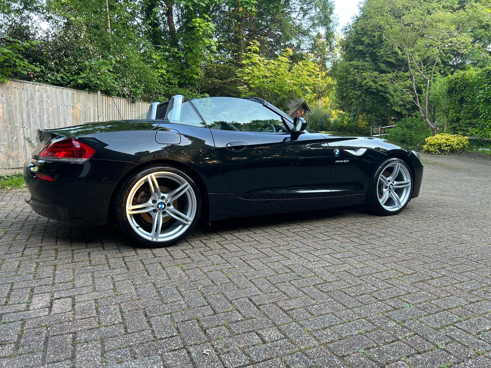 Black BMW E89 Z4 roadster with the roof down, viewed from the rear